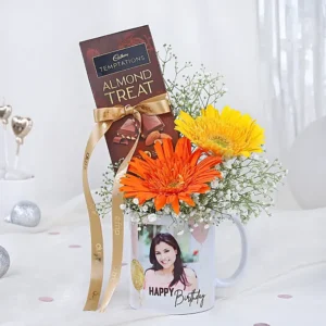 Personalized photo mug with gerbera flowers and Cadbury Temptations same day delivery Burdwan